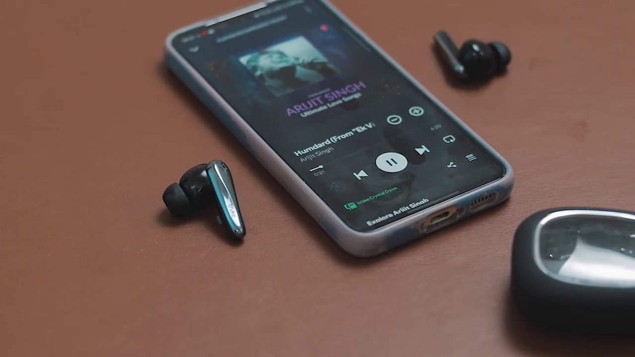 A shot showing the earbuds placed in the ear, demonstrating their size and fit relative to the ear.
